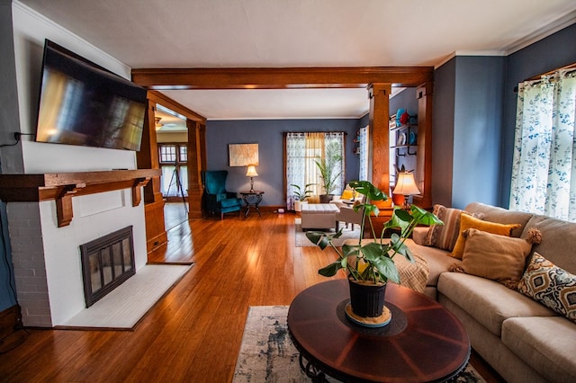818 W Water St, Elmira, NY 14905 - living room with wood finished floors, a fireplace, and crown molding