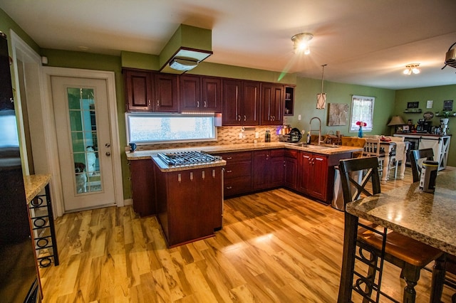 818 W Water St, Elmira, NY 14905 - kitchen with a peninsula, stainless steel gas stovetop, light wood finished floors, and light countertops