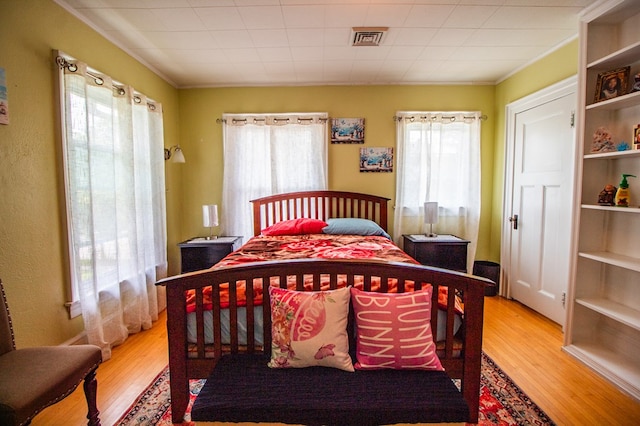 818 W Water St, Elmira, NY 14905 - bedroom with multiple windows, wood finished floors, and ornamental molding