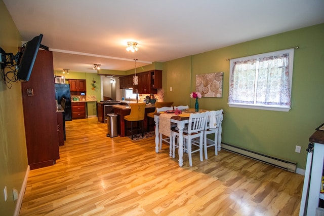 818 W Water St, Elmira, NY 14905 - dining area featuring a baseboard radiator and light wood-style floors