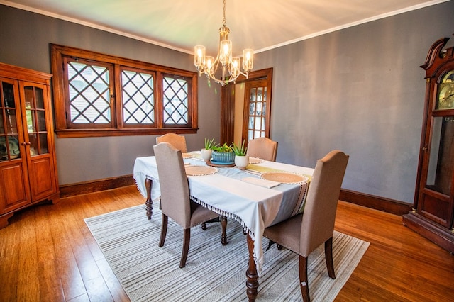 818 W Water St, Elmira, NY 14905 - dining area with a chandelier, light wood-style floors, healthy amount of natural light, and ornamental molding