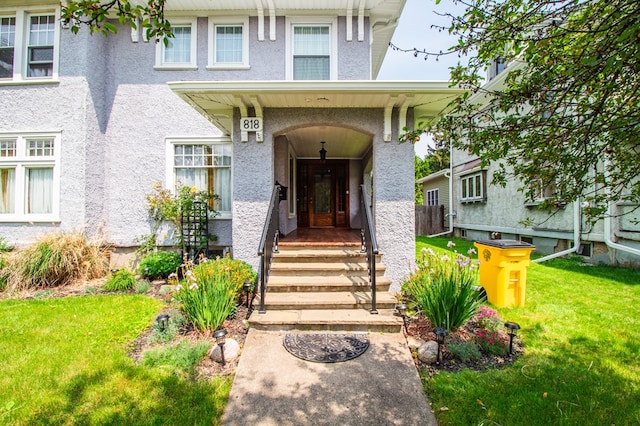 818 W Water St, Elmira, NY 14905 - property entrance featuring a yard and stucco siding