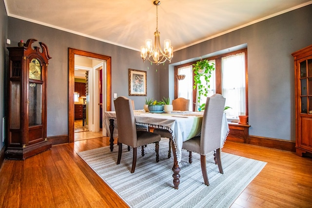 818 W Water St, Elmira, NY 14905 - dining room with a chandelier, light wood-style flooring, and ornamental molding
