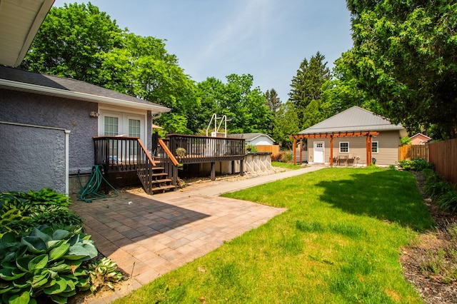 818 W Water St, Elmira, NY 14905 - fenced yard featuring a wooden deck, a patio, and view of wooded area