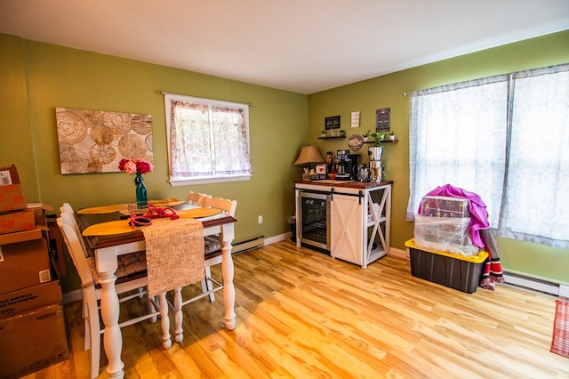 818 W Water St, Elmira, NY 14905 - dining space with wood finished floors, a baseboard heating unit, and beverage cooler