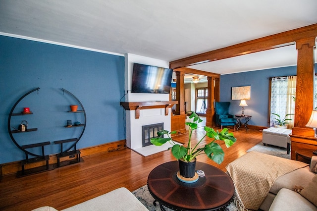 818 W Water St, Elmira, NY 14905 - living room featuring wood finished floors, a fireplace, and ornate columns