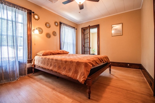 818 W Water St, Elmira, NY 14905 - bedroom featuring crown molding, multiple windows, hardwood / wood-style flooring, and ceiling fan