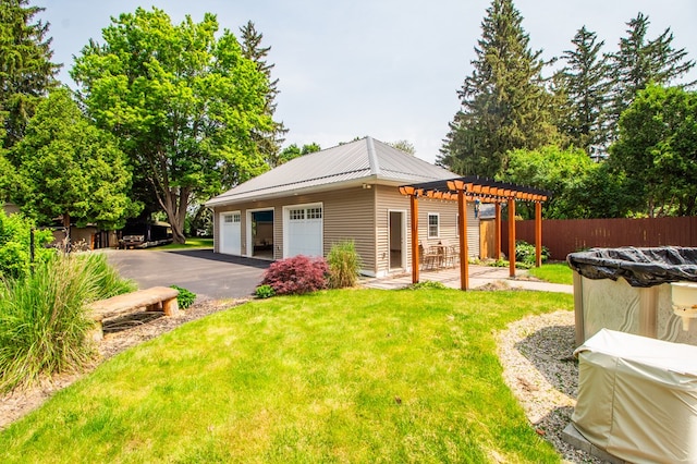 818 W Water St, Elmira, NY 14905 - rear view of house featuring a pergola, a garage, an outdoor structure, a metal roof, and driveway