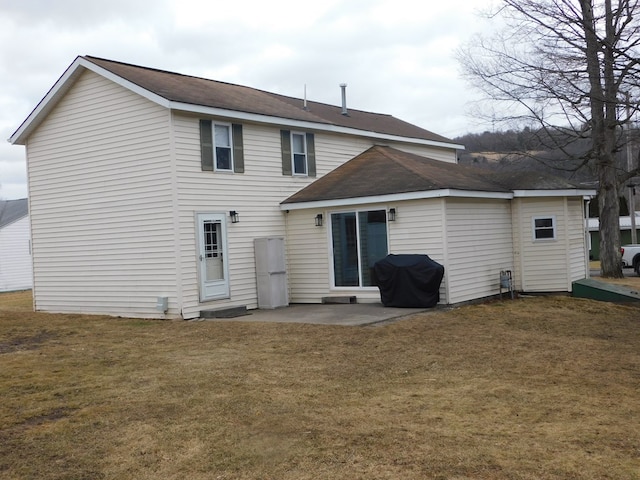 back of property with a patio and a lawn