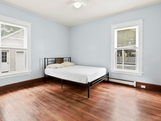 29 Cadwell Ave, Waverly, NY 14892 - bedroom featuring a baseboard radiator, wood finished floors, baseboards, and ceiling fan
