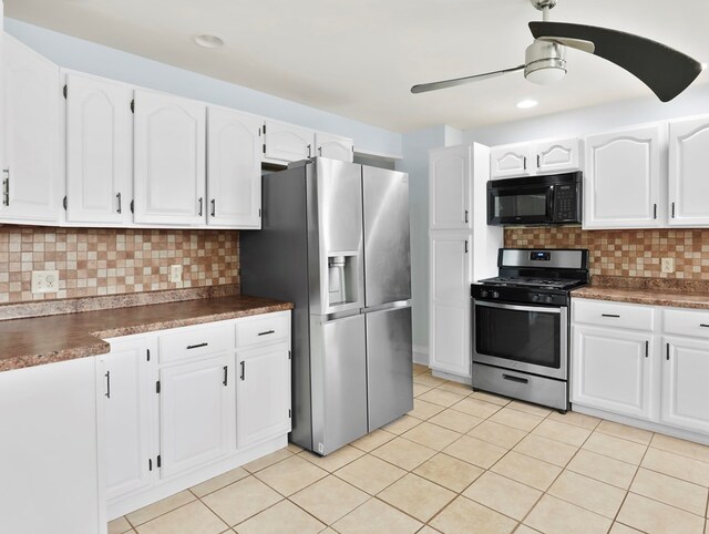 29 Cadwell Ave, Waverly, NY 14892 - kitchen with stainless steel appliances, dark countertops, backsplash, and white cabinets