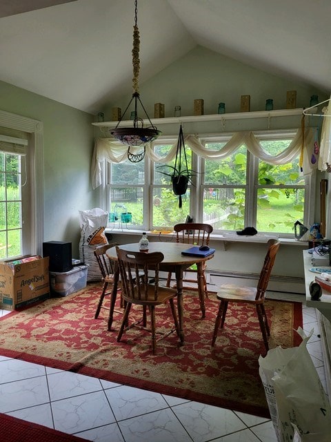 tiled dining area with lofted ceiling