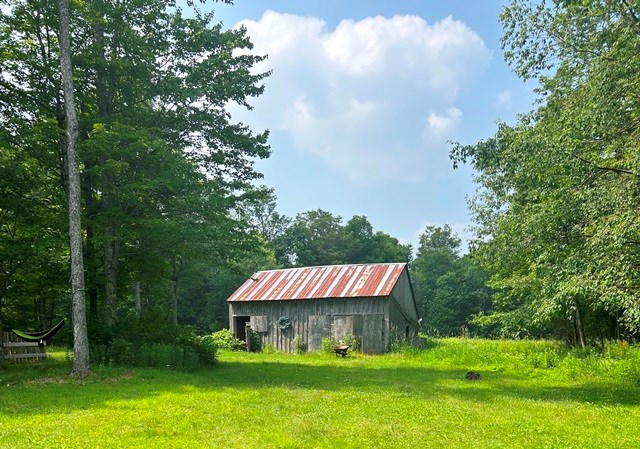 view of outdoor structure featuring a lawn