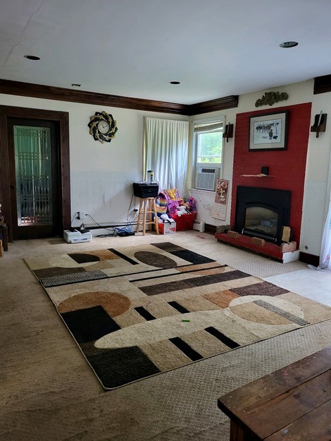 interior space featuring light carpet and ornamental molding