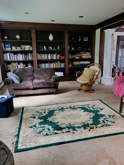 carpeted living room with built in shelves