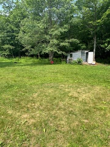 156 Hillcrest Dr, Coudersport, PA 16915 - spare room with dark hardwood / wood-style flooring, crown molding, and a chandelier