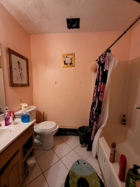 full bathroom featuring vanity, tile patterned floors, toilet, a textured ceiling, and shower / tub combo with curtain