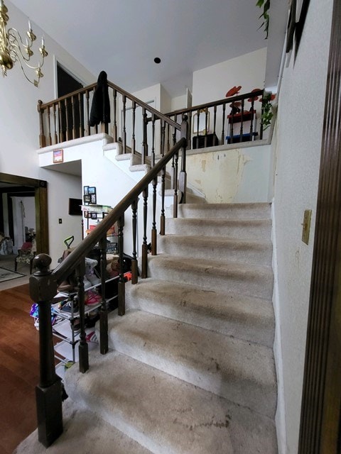 staircase featuring a chandelier