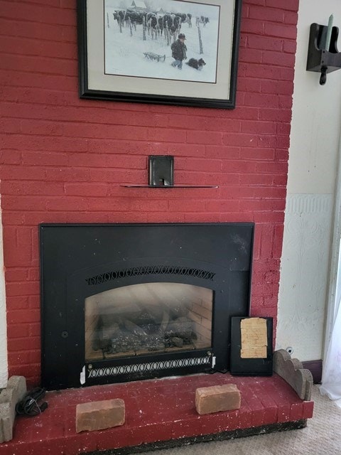 room details with carpet floors and a brick fireplace