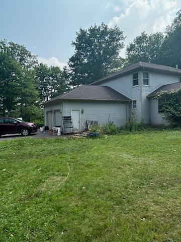 view of home's exterior featuring a yard and a garage