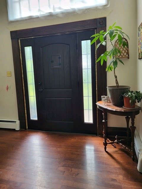 entryway with hardwood / wood-style floors and a baseboard radiator