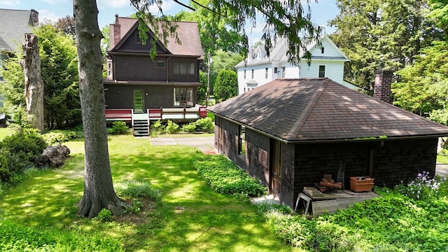 76 Front St, Owego, NY 13827 - rear view of house featuring a wooden deck, a chimney, a lawn, and roof with shingles