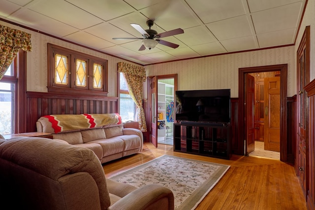 76 Front St, Owego, NY 13827 - living room featuring healthy amount of natural light, ceiling fan, a wainscoted wall, light wood-style floors, and wallpapered walls