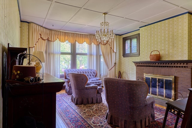76 Front St, Owego, NY 13827 - living room featuring wallpapered walls, plenty of natural light, a chandelier, and a brick fireplace