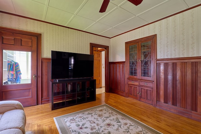 76 Front St, Owego, NY 13827 - living area with wood finished floors, wainscoting, ceiling fan, and ornamental molding