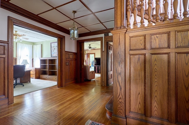 76 Front St, Owego, NY 13827 - hall featuring a desk, crown molding, a wainscoted wall, wooden walls, and parquet flooring