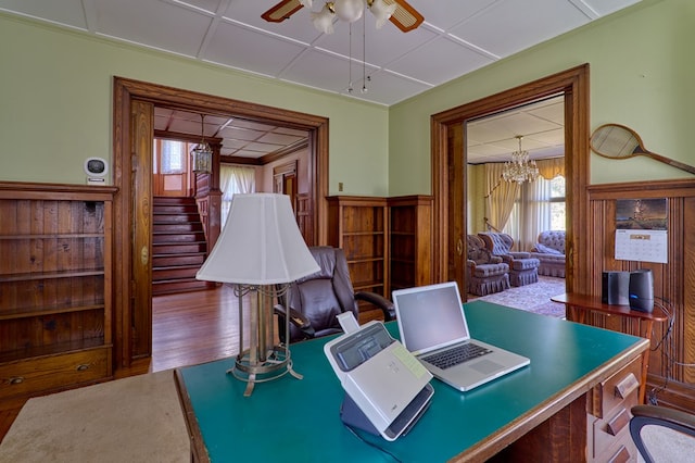 76 Front St, Owego, NY 13827 - home office featuring healthy amount of natural light, a ceiling fan, wainscoting, wood finished floors, and a chandelier