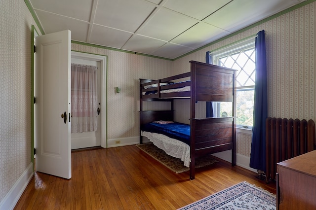 76 Front St, Owego, NY 13827 - bedroom featuring hardwood / wood-style flooring, radiator, wallpapered walls, and baseboards