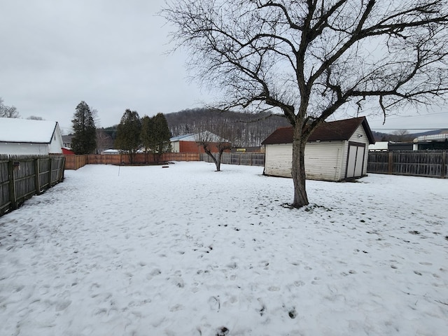 snowy yard with a shed