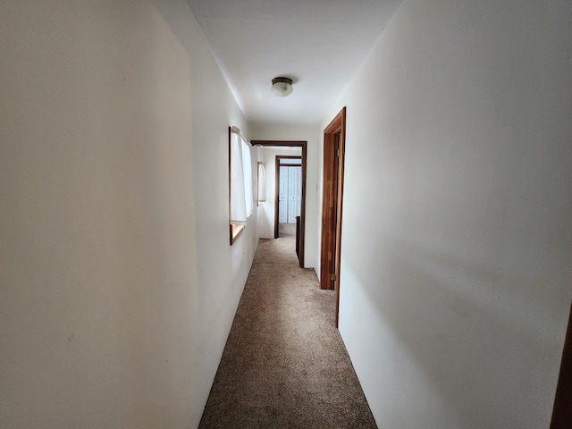 hall with light colored carpet