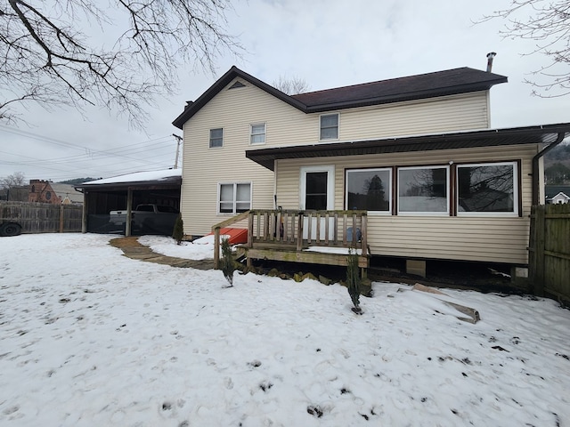 snow covered property featuring a deck