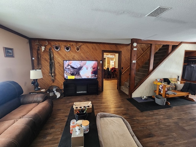 living room featuring dark hardwood / wood-style floors and a textured ceiling