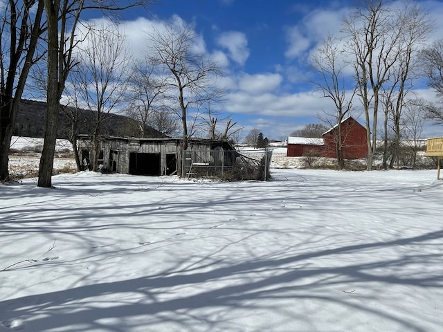 yard covered in snow with an outdoor structure