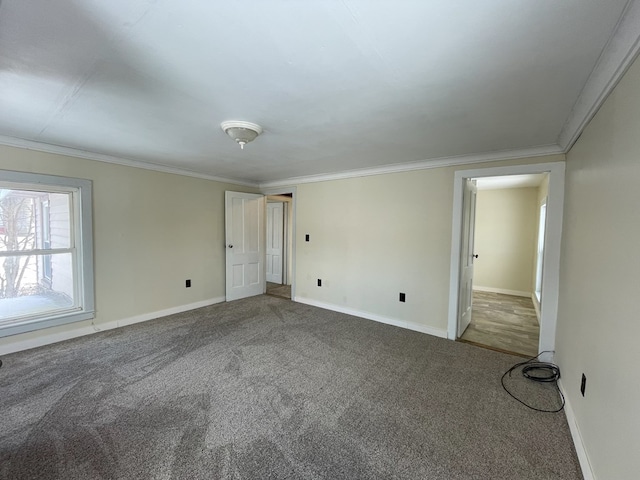 carpeted spare room featuring ornamental molding