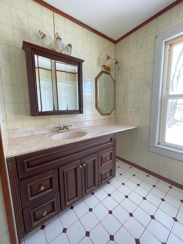 bathroom featuring tile walls, vanity, a wealth of natural light, and ornamental molding