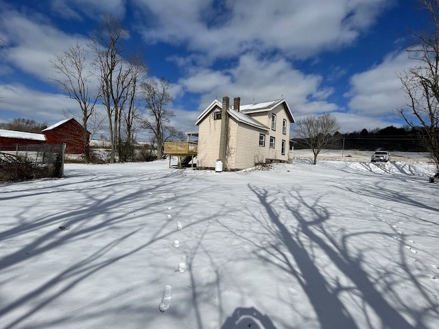 snowy yard featuring a wooden deck