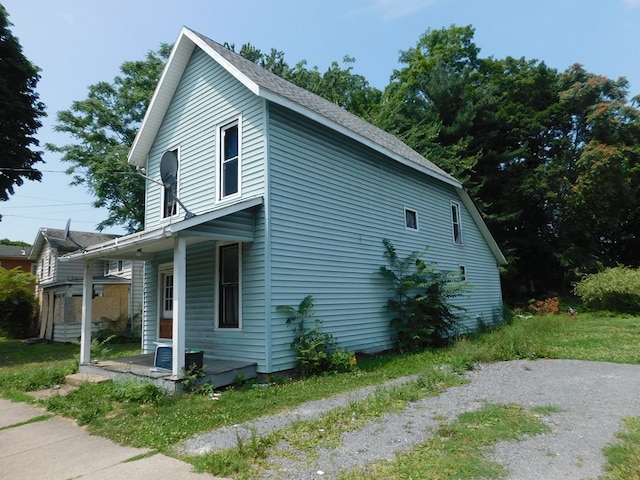 view of home's exterior featuring a porch and cooling unit