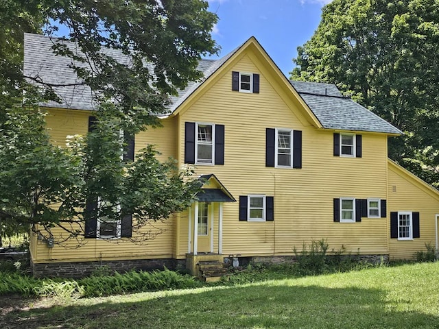 rear view of house with a lawn