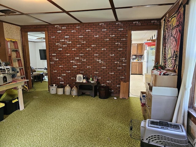 misc room with heating unit and brick wall