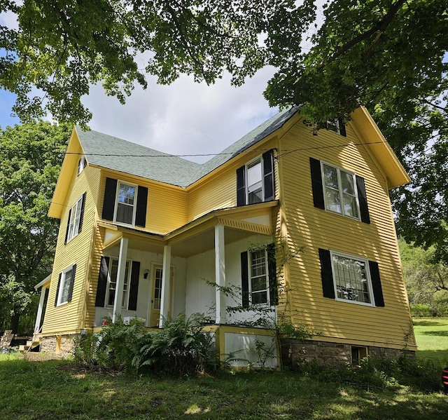 view of side of home featuring a porch