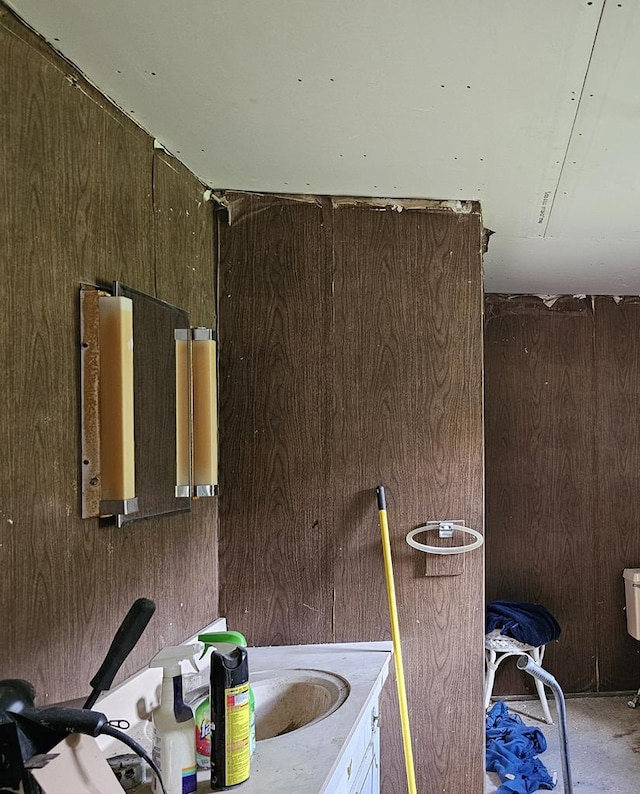 bathroom featuring wooden walls