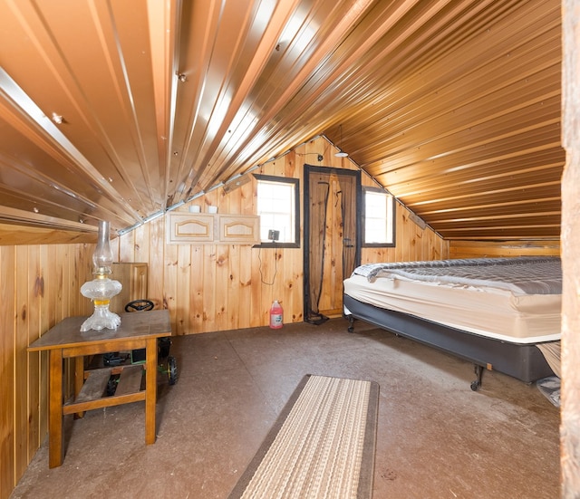 bedroom with wooden walls and lofted ceiling