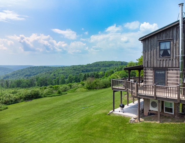 436 Teeter Rd, Genesee, PA 16923 - view of green lawn with a deck, a patio area, and a wooded view