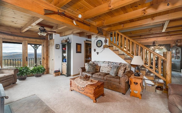 436 Teeter Rd, Genesee, PA 16923 - carpeted living room featuring a wooden ceiling with exposed beams, stairway, a chandelier, a ceiling fan, and tile patterned flooring