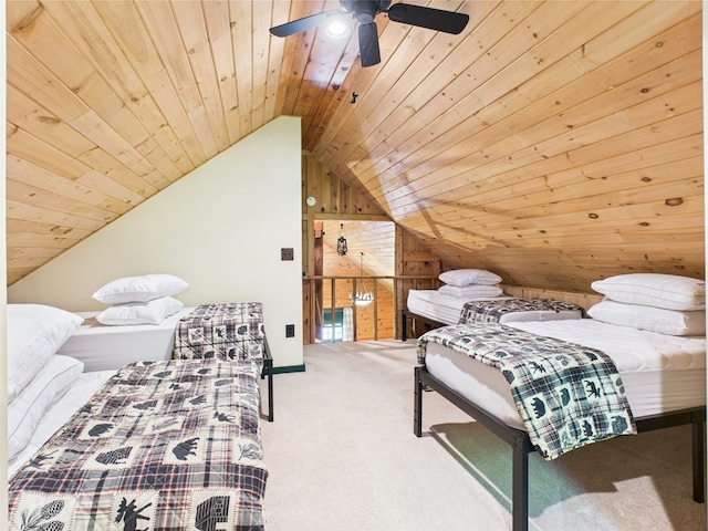 carpeted bedroom featuring wooden walls, lofted ceiling, wooden ceiling, and ceiling fan