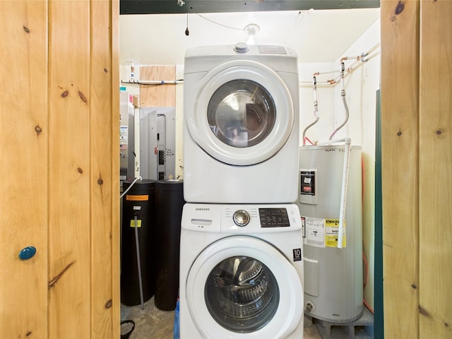 laundry room featuring stacked washer / drying machine and water heater